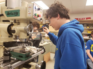 Spartronics student working on a machine
