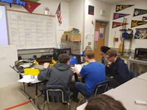 Spartronics students working together on a computer