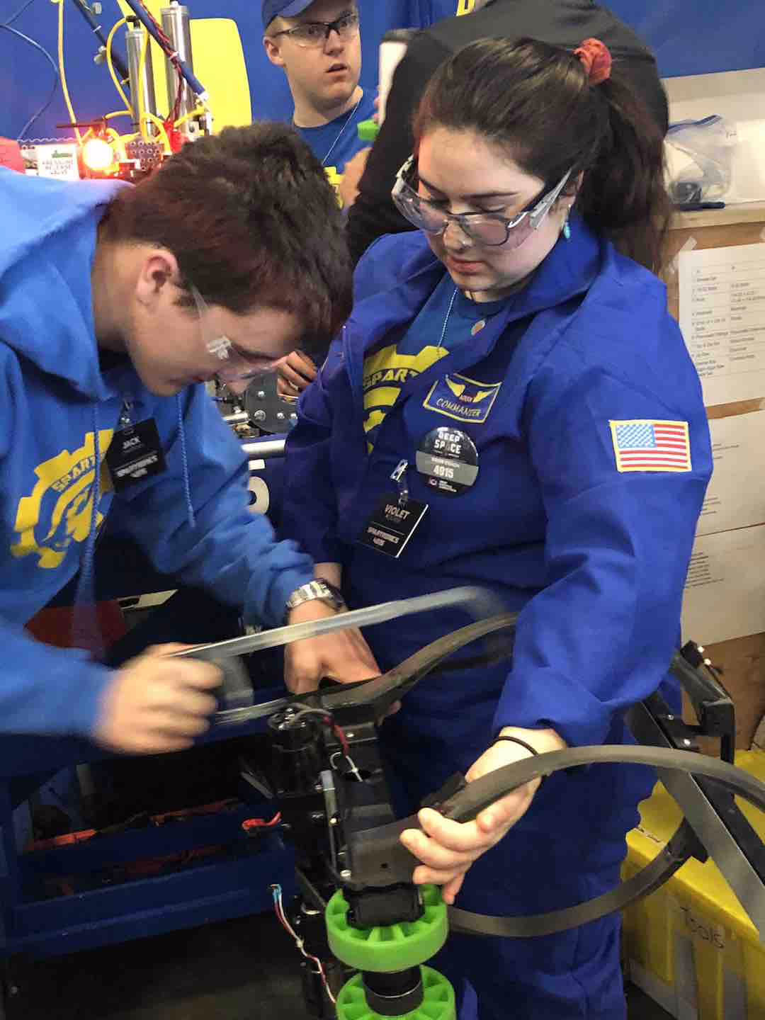 Spartronics drive team work on robot